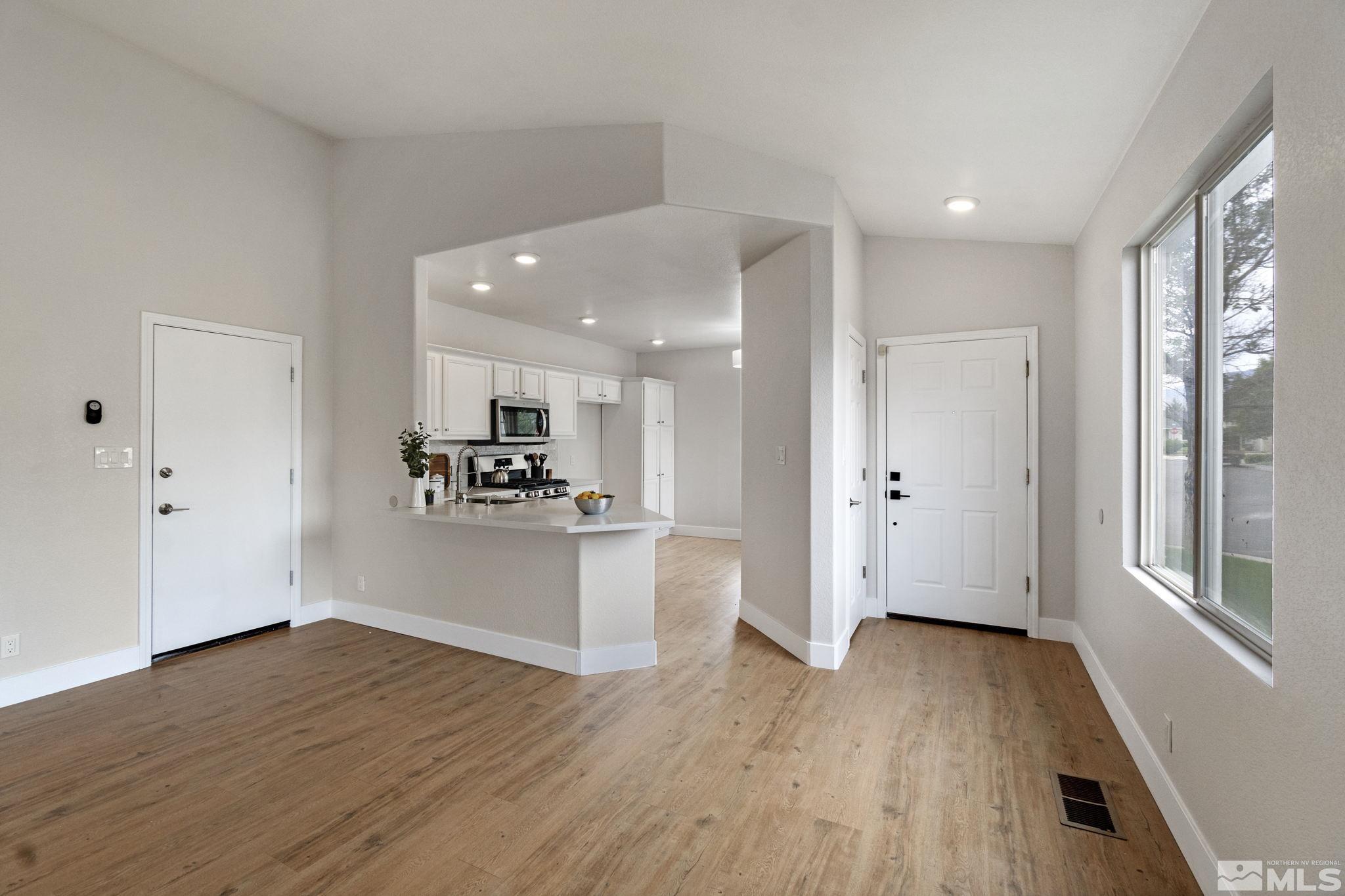 10000 Eagles Landing Court Reno, NV 89521 - Photo 9 of 37 a view of a big room with wooden floor and windows