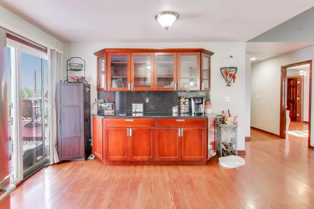 wooden floor in a living room with a large window