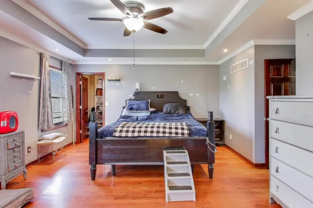 a bedroom with a bed and a chandelier