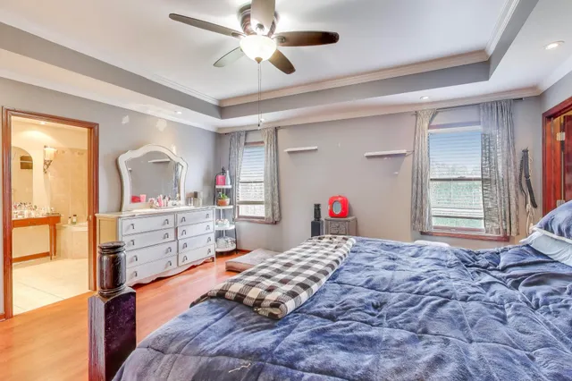 a bedroom with a large bed and a chandelier