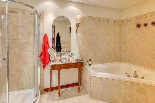 a bathroom with a bathtub and a shower