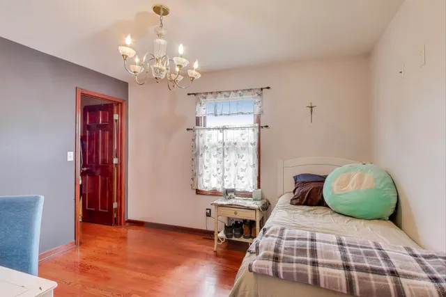 a bedroom with a bed and a chandelier