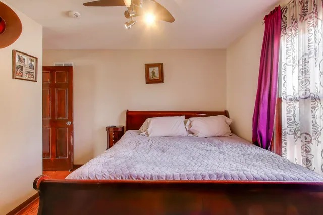 a bedroom with a bed and a window