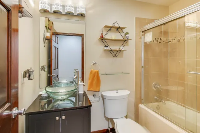 a bathroom with a sink toilet and shower