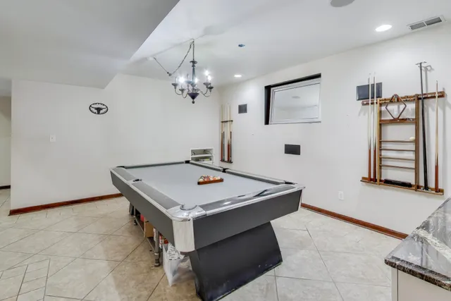 a room with pool table and window