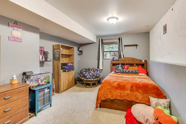 a bedroom with bed and a window