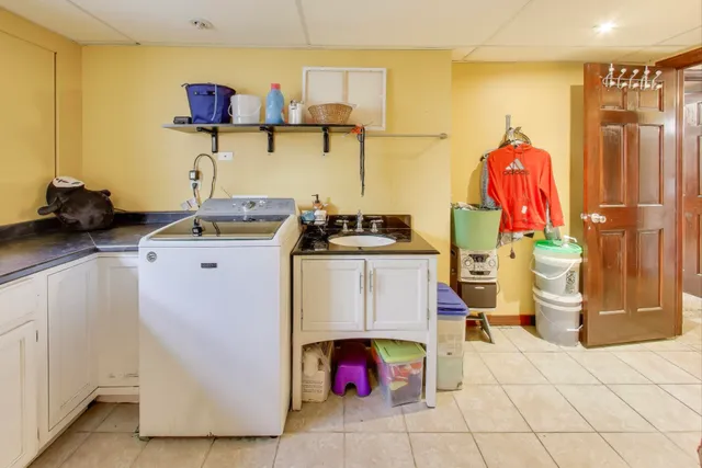 a utility room with multiple dryer and washer