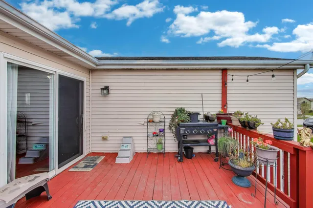 a balcony with furniture and wooden floor