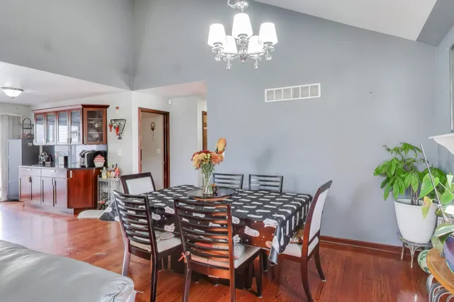 a view of a dining room with furniture and wooden floor