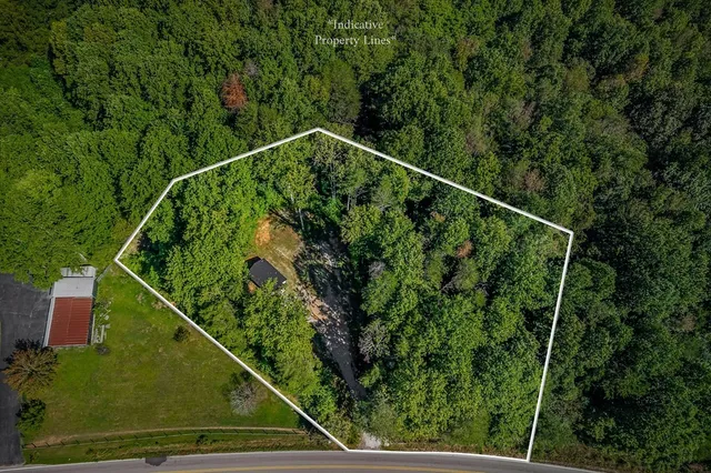 an aerial view of a house with yard