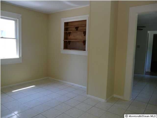 634 Fort Plains Road Howell, NJ 07731 - Photo 2 of 14 an empty room that has a window in it