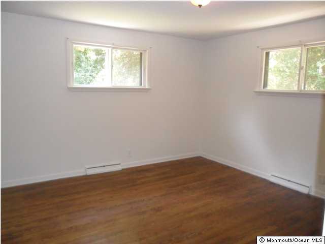 634 Fort Plains Road Howell, NJ 07731 - Photo 5 of 14 an empty room with windows