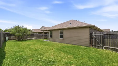a view of a backyard with potted plants and wooden fence