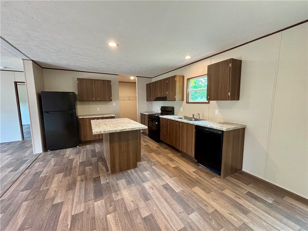 703 Double Springs Road Townville, SC 29689 - Photo 7 of 22 This spacious kitchen offers a functional layout with ample counter space and contemporary flooring.
