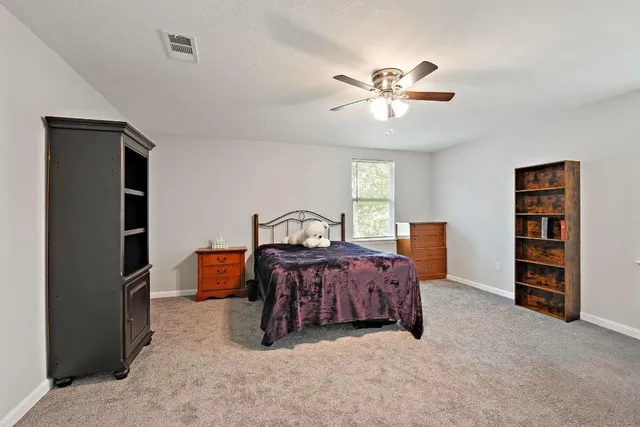 a bed room with a bed and a book shelf