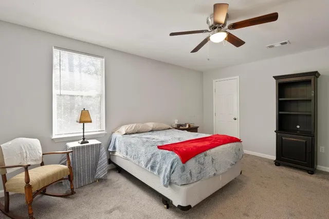 a bed room with a bed and a window