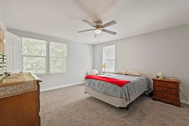 a spacious bedroom with a bed and a window
