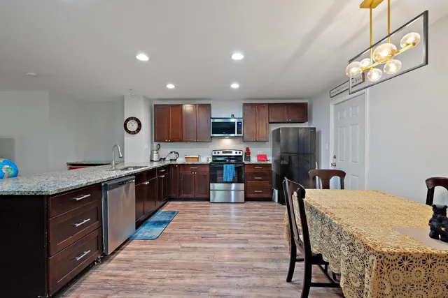 a kitchen with granite countertop lots of counter top space and appliances