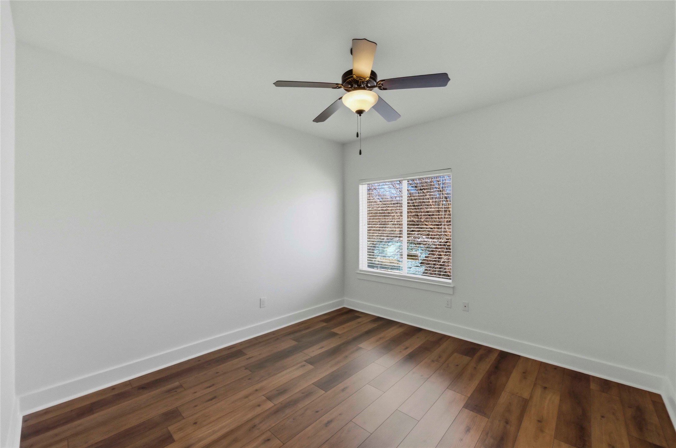 1620 Haskell Street, Unit B Austin, TX 78702 - Photo 18 of 27 an empty room with wooden floor ceiling fan and window