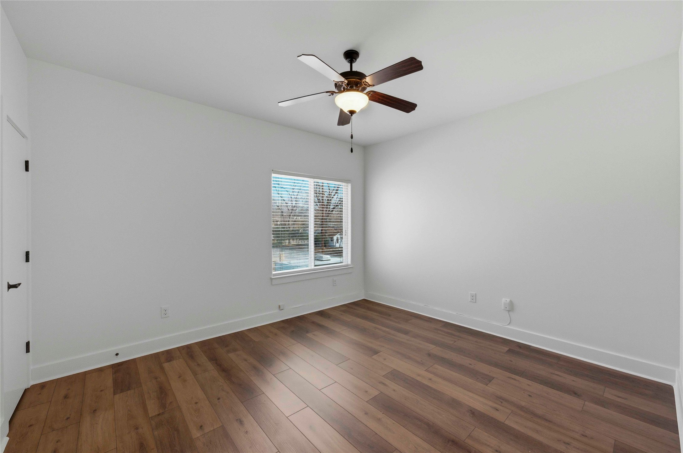 1620 Haskell Street, Unit B Austin, TX 78702 - Photo 21 of 27 wooden floor in an empty room with a window