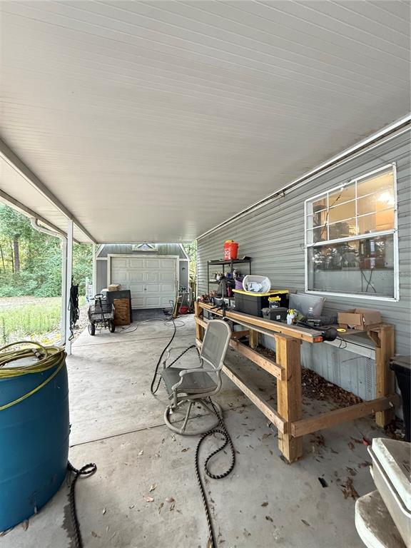 5109 Southwest 10th Street Bell, FL 32619 - Photo 18 of 38 a room with furniture a flat screen tv and a large window