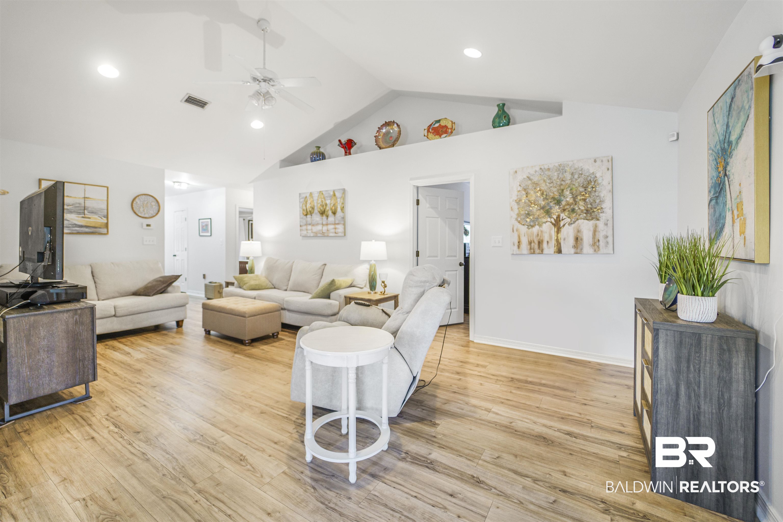 4620 Pine Boulevard Orange Beach, AL 36561 - Photo 7 of 49 Living room with a ceiling fan, light wood-style flooring, high vaulted ceiling, and recessed lighting