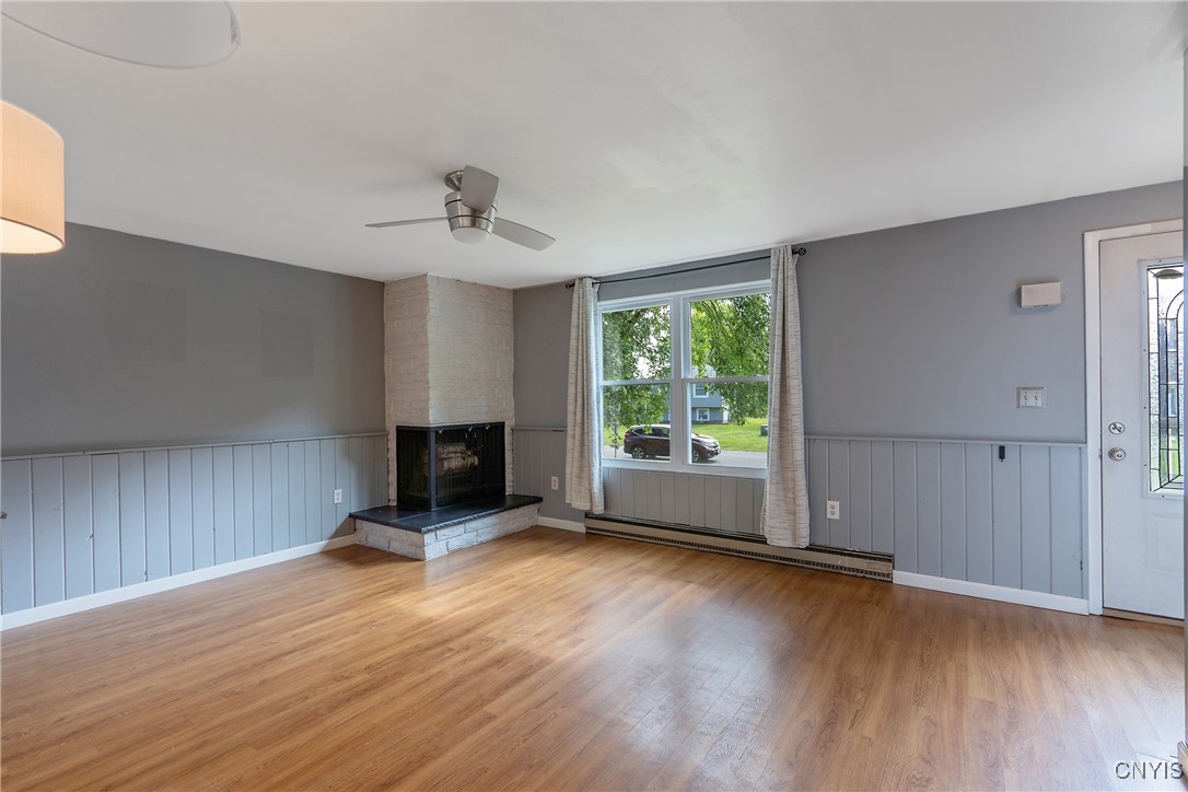 9582 Tagus Lane Cicero, NY 13029 - Photo 5 of 30 In the corner is a chic corner fireplace with whit