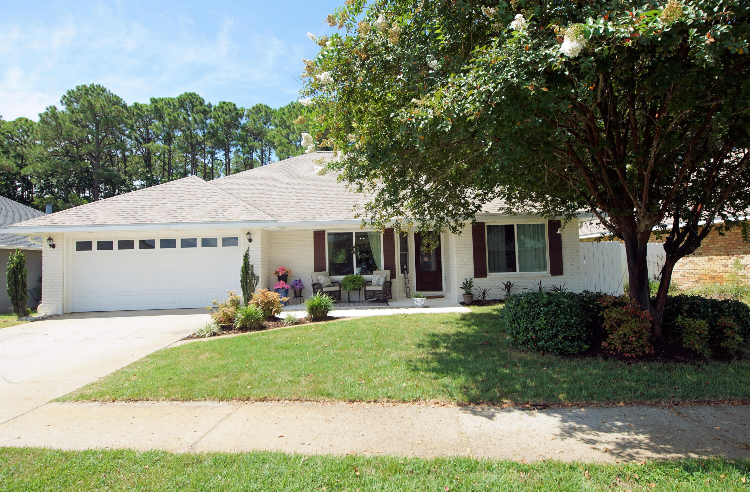 a view of a house with a yard and sitting area