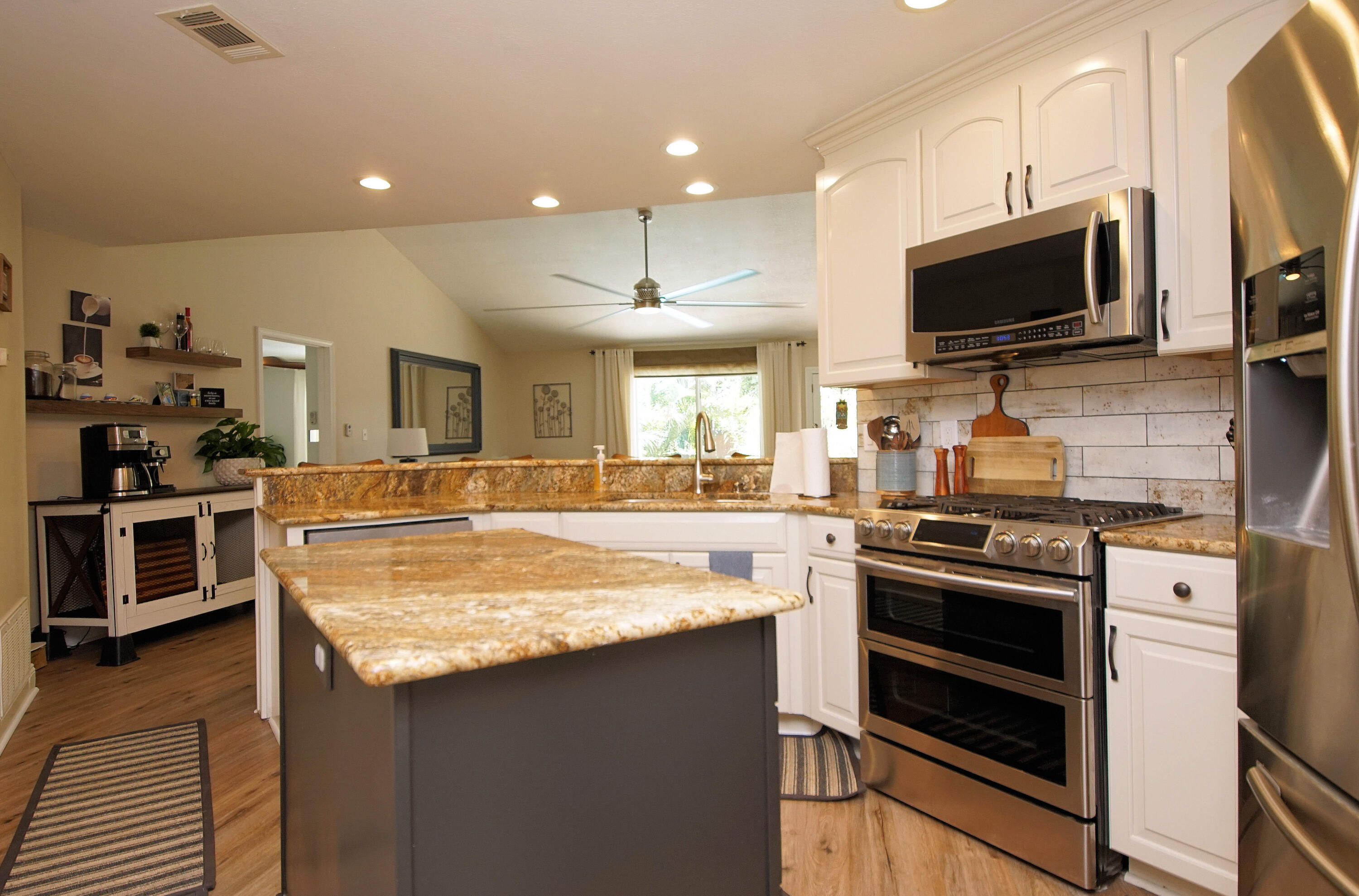 3912 Mesa Road Destin, FL 32541 - Photo 14 of 44 a kitchen with stainless steel appliances a stove sink and microwave