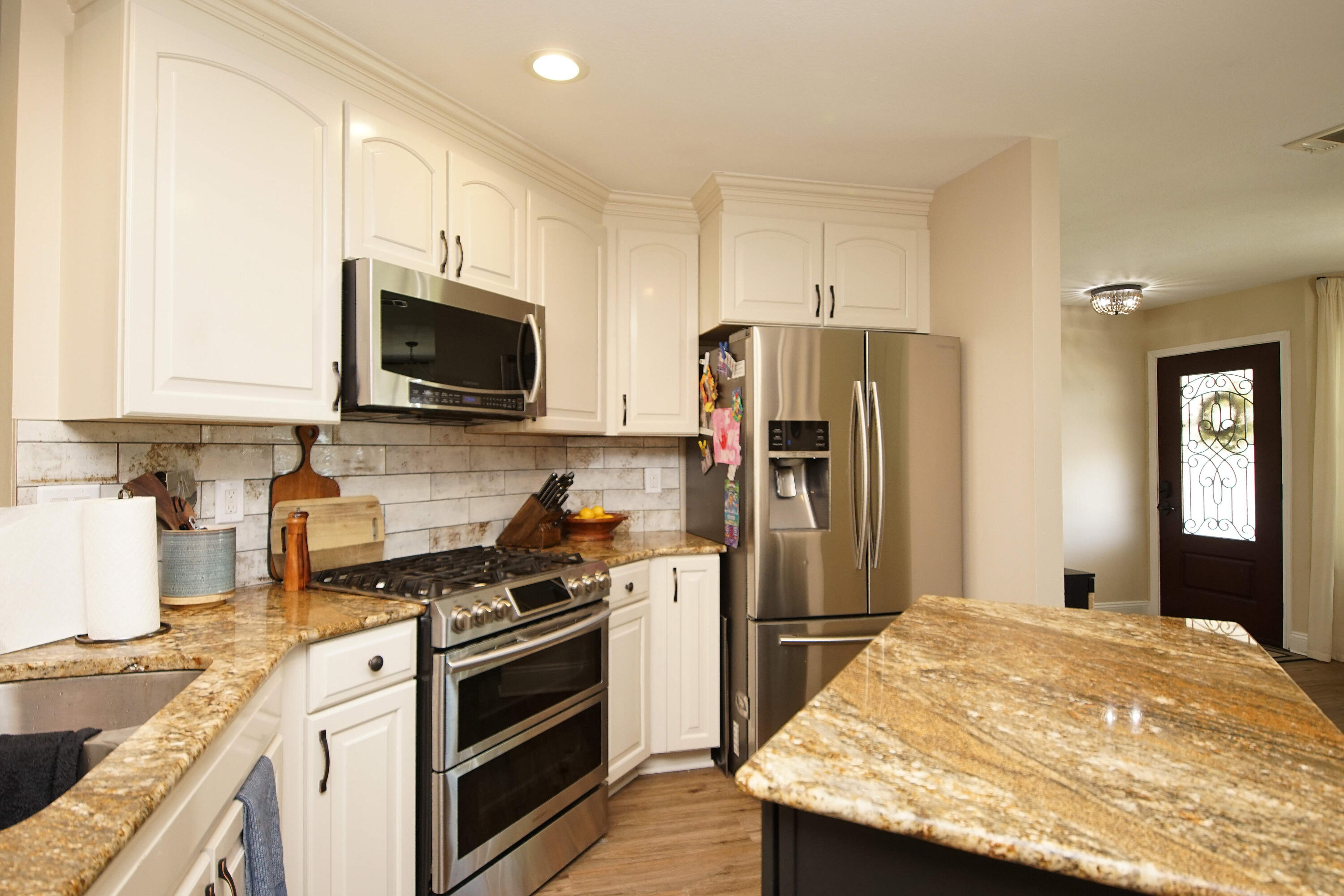 3912 Mesa Road Destin, FL 32541 - Photo 16 of 44 a kitchen with a stove a refrigerator and a sink
