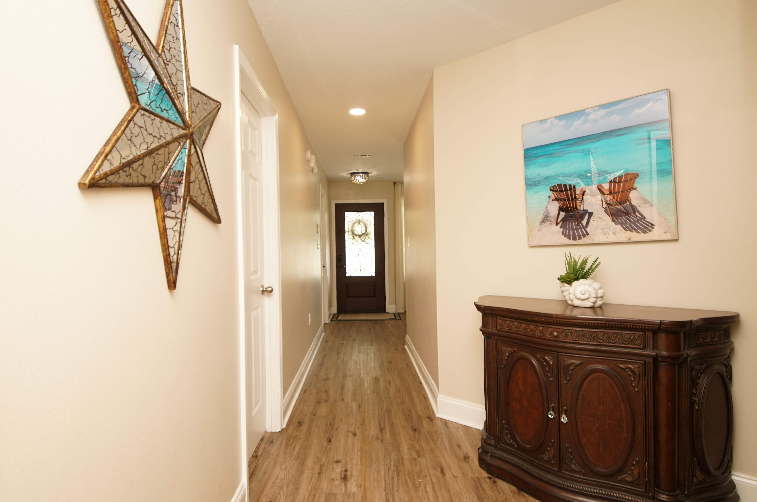 3912 Mesa Road Destin, FL 32541 - Photo 28 of 44 a view of a hallway with wooden floor and staircase
