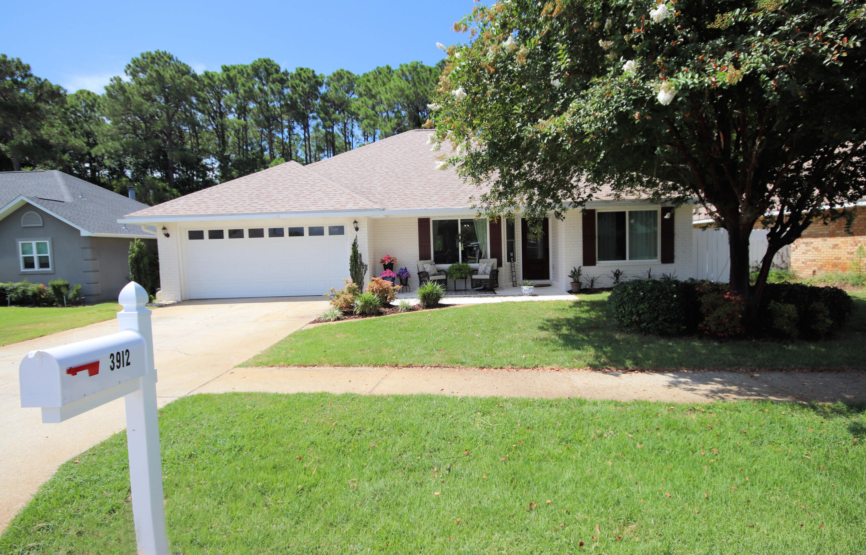 3912 Mesa Road Destin, FL 32541 - Photo 9 of 44 a front view of house with yard and green space
