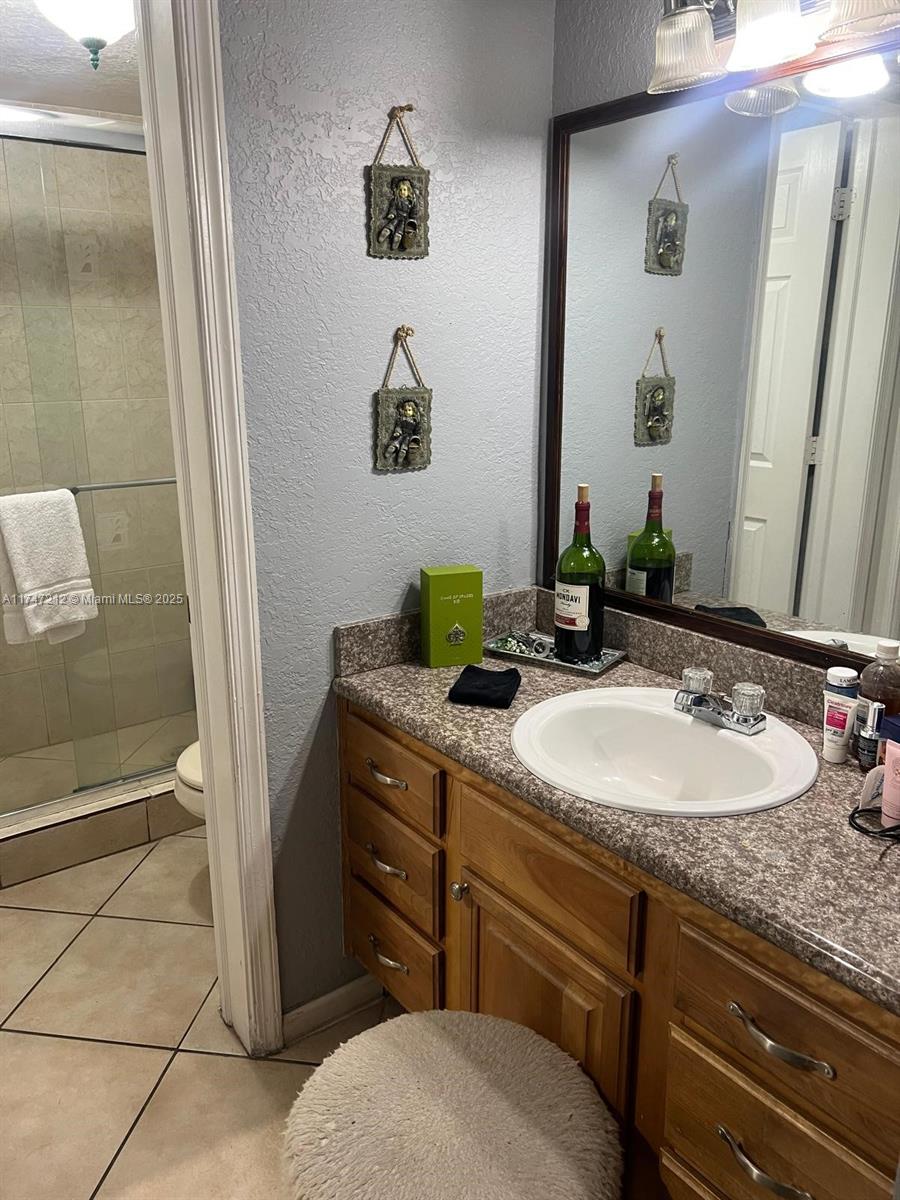 3057 Coral Springs Drive, Unit 102 Coral Springs, FL 33065 - Photo 17 of 26 a bathroom with a sink and a mirror