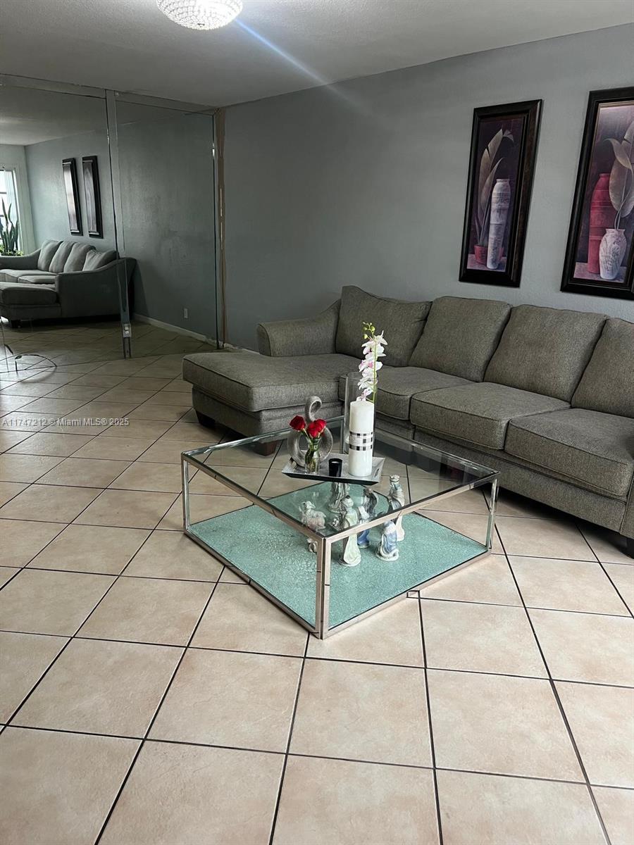 3057 Coral Springs Drive, Unit 102 Coral Springs, FL 33065 - Photo 10 of 26 a living room with furniture and a potted plant