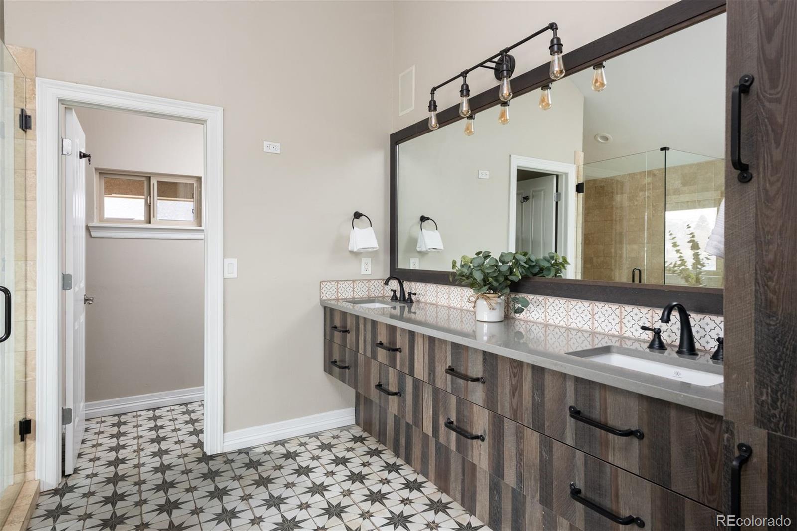 1214 South Fillmore Street Denver, CO 80210 - Photo 33 of 50 a bathroom with a double vanity sink mirror and shower
