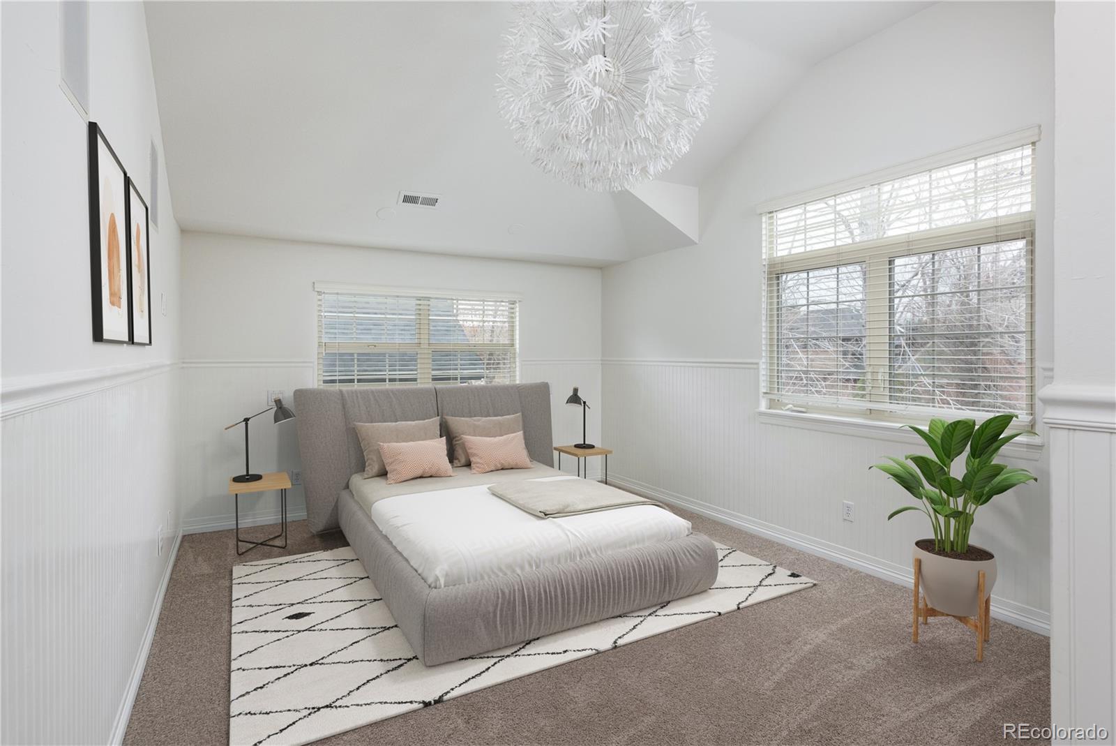 1214 South Fillmore Street Denver, CO 80210 - Photo 37 of 50 a bedroom with a large bed and a potted plant
