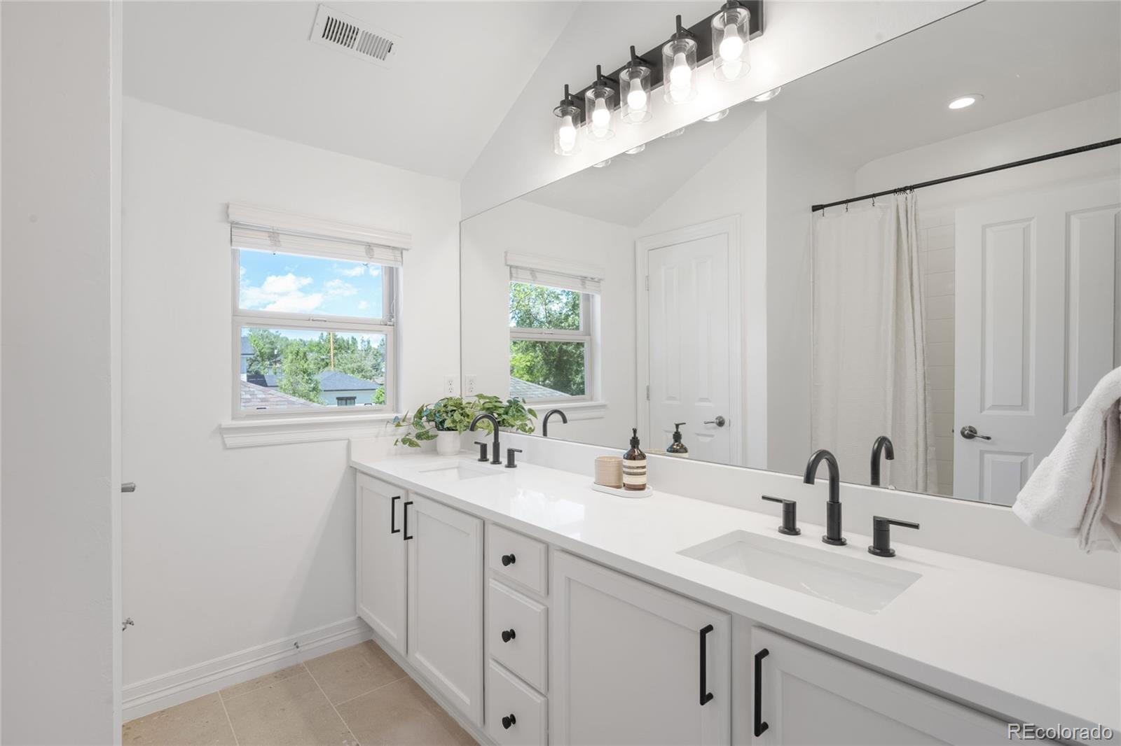 1214 South Fillmore Street Denver, CO 80210 - Photo 41 of 50 a bathroom with a sink and a window