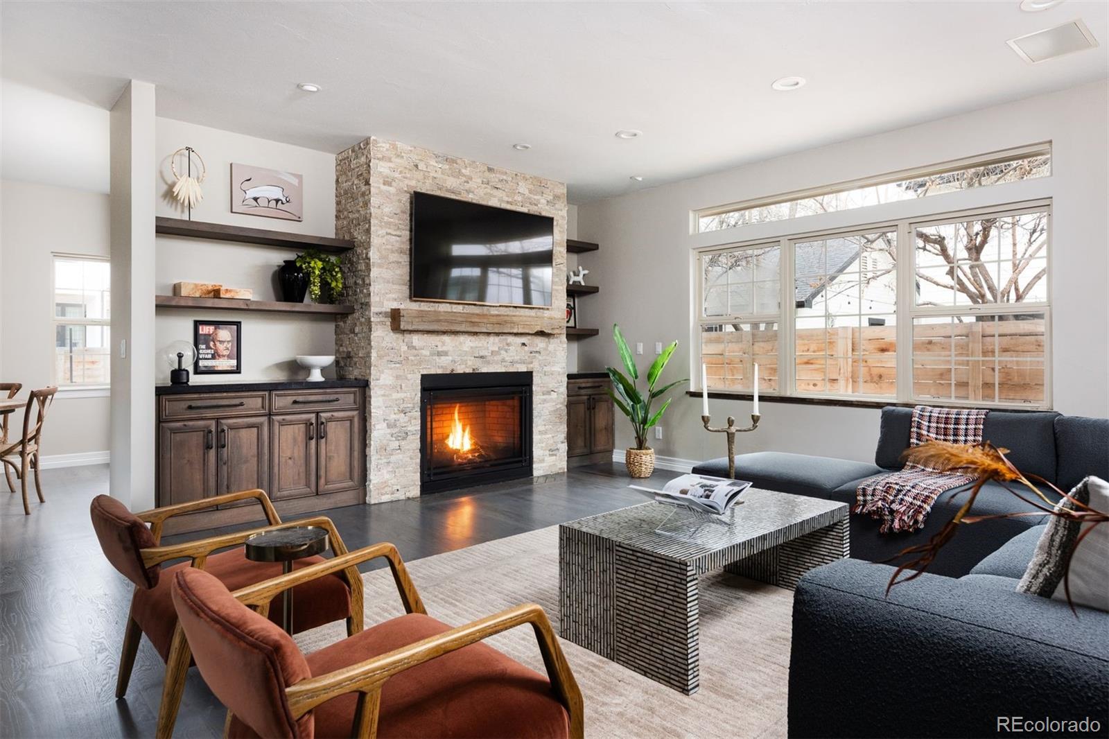 1214 South Fillmore Street Denver, CO 80210 - Photo 6 of 50 a living room with furniture a fireplace and a flat screen tv
