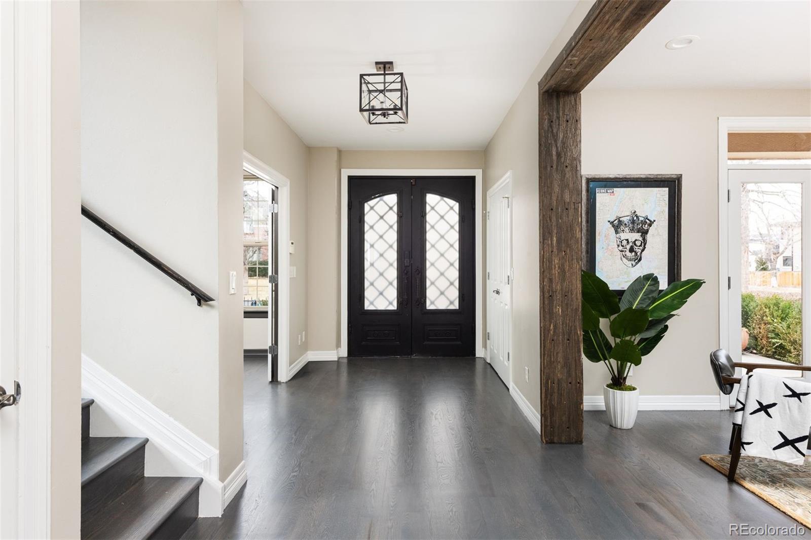 1214 South Fillmore Street Denver, CO 80210 - Photo 10 of 50 a view of entryway with wooden floor and stairs