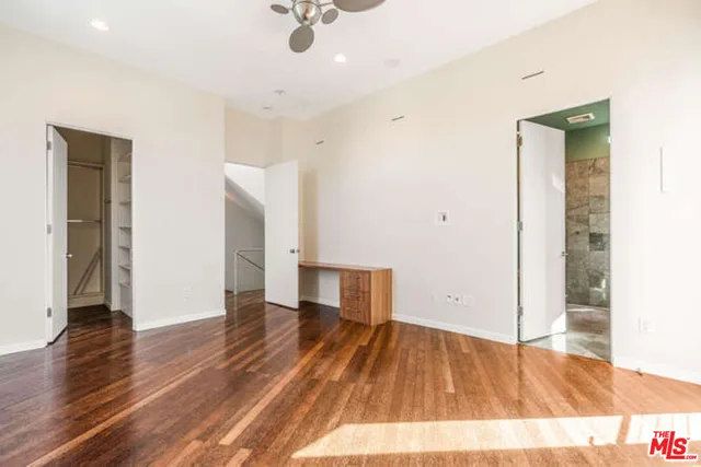 a view of walk in closet with empty racks