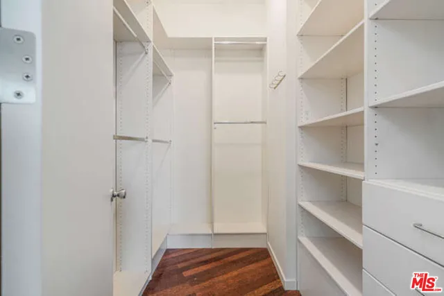 a bathroom with a granite countertop sink a toilet a mirror and shower