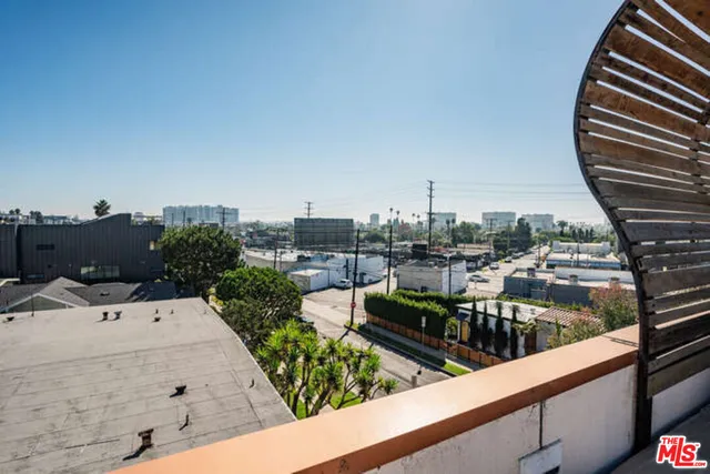a view of a balcony with a table and chairs
