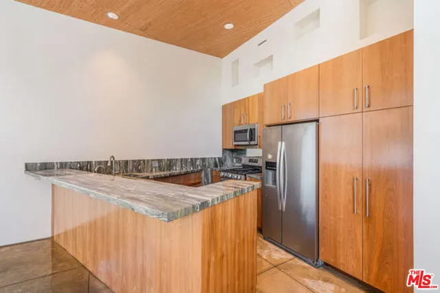 a kitchen with granite countertop a sink and a counter top space