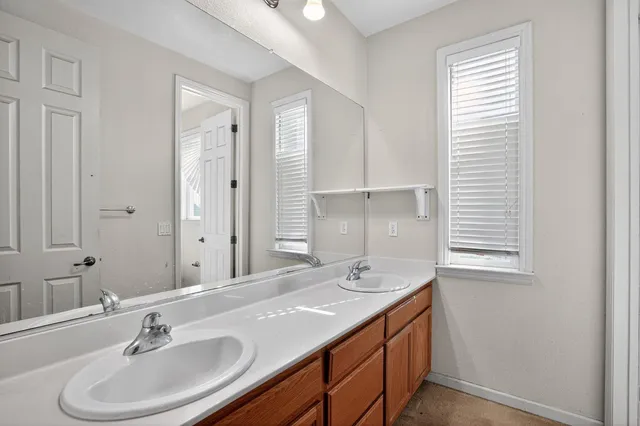 a bathroom with a sink double vanity and a mirror