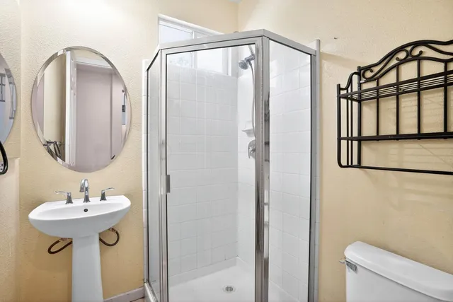 a bathroom with a sink toilet and shower