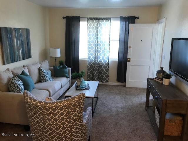 3126 Belden Circle, Unit 2 Jacksonville, FL 32207 - Photo 3 of 13 a living room with furniture and a flat screen tv