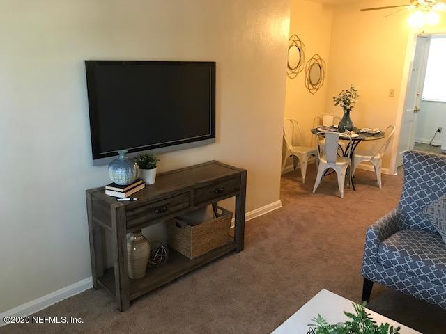 3126 Belden Circle, Unit 2 Jacksonville, FL 32207 - Photo 4 of 13 a living room with furniture and a flat screen tv
