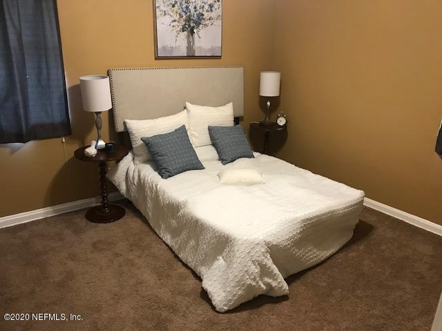 3126 Belden Circle, Unit 2 Jacksonville, FL 32207 - Photo 5 of 13 a bedroom with a bed and wall painting