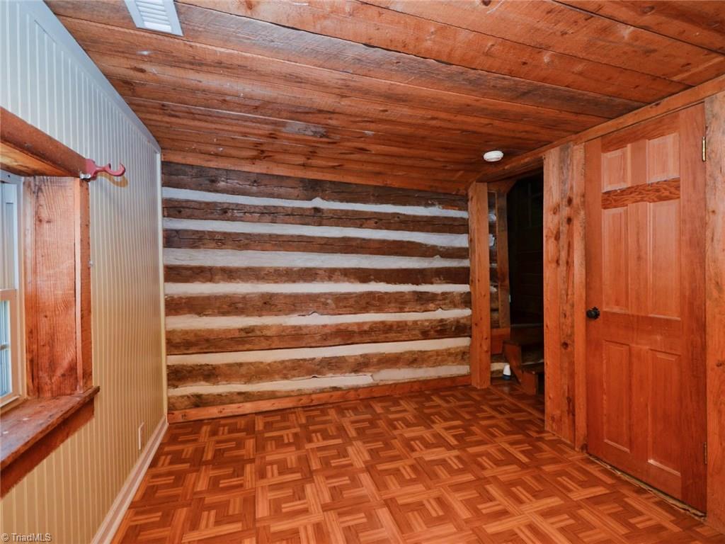 171 Guy Gaither Road Harmony, NC 28634 - Photo 18 of 21 3rd bedroom upstairs has exposed log and wood ceiling making it extra cozy.