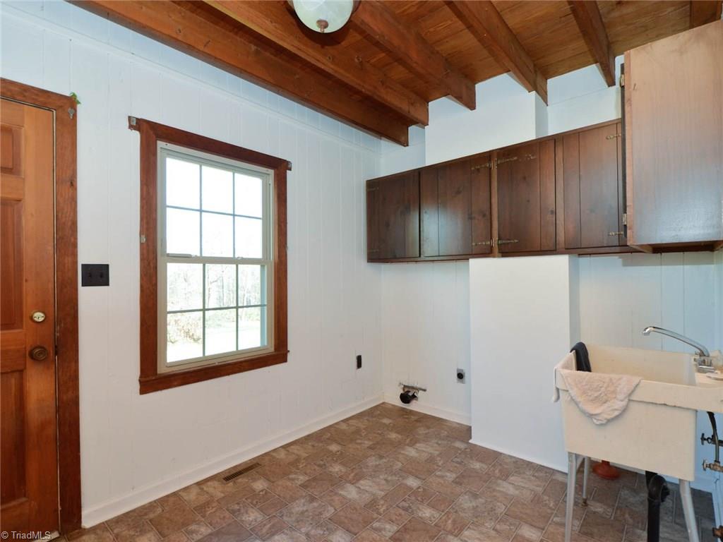 171 Guy Gaither Road Harmony, NC 28634 - Photo 21 of 21 Large laundry room has plenty of storage space and exits onto the side porch.